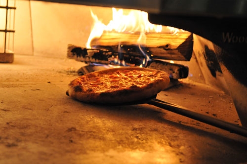 Pizza in fire brick oven